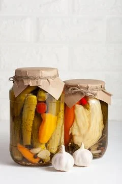 Assorted pickled vegetables in jars with garlic Stock Photos