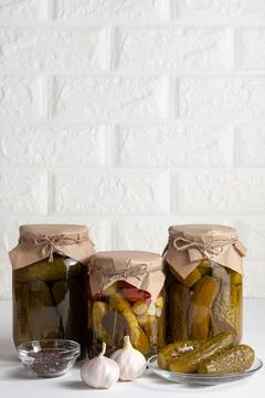 Assorted pickled vegetables in jars with spices and fresh garlic. Copy space Stock Photos