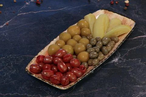 Assorted Pickled Vegetables on Rectangular Plate, Marble Background Stock Photos