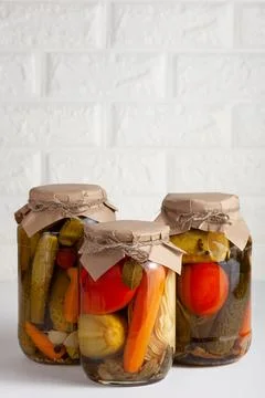 Assorted Pickled Vegetables in Rustic Jars. Copy space Stock Photos