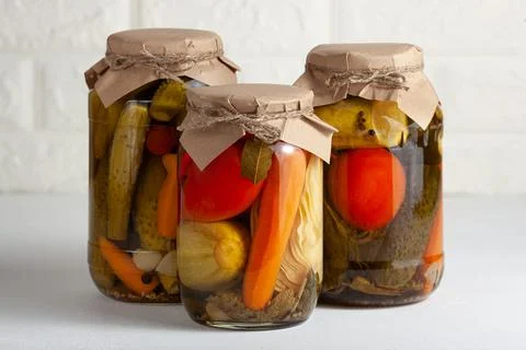 Assorted Pickled Vegetables in Rustic Jars Stock Photos