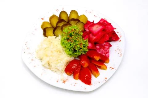 Assorted pickles and pickled vegetables served on white plate. Ukrainian Stock Photos
