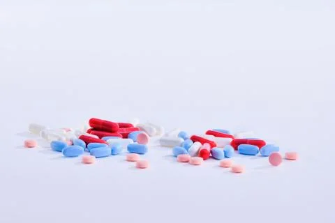 Assorted pills and capsules on a light background Stock Photos