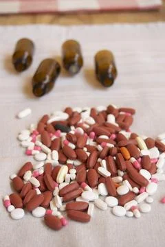 Assorted pills and empty bottles Stock Photos