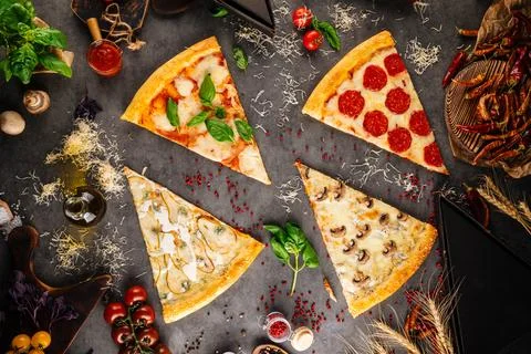 Assorted pizza slices with different toppings Foto stock