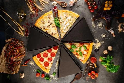 Assorted pizza slices with different toppings Stock Photos
