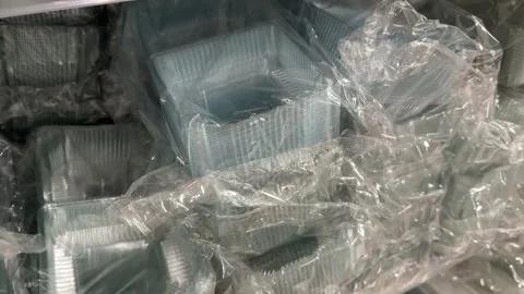 Assorted plastic storage containers and packaging boxes displayed on retail Stock Footage 345173034