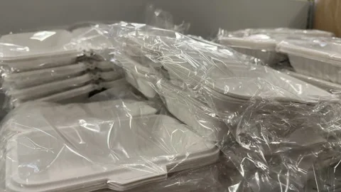 Assorted plastic storage containers and packaging boxes displayed on retail Stock Footage 345173458