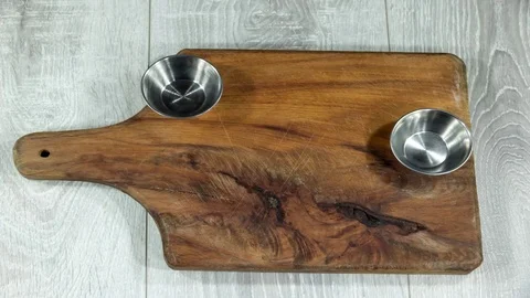 Assorted potato and corn chips put on a wooden board, sauce. Time lapse. Stock Footage 123787676