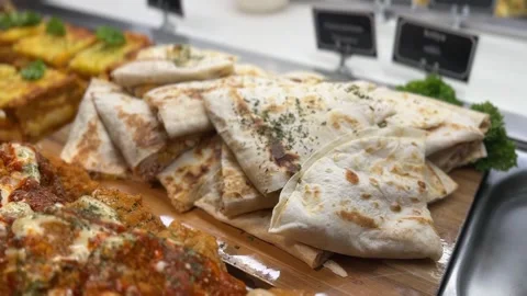 Assorted prepared foods with lasagna flatbread and cheesy baked chicken Stock Footage 316812807