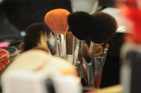 Assorted professional makeup brushes and cosmetic tools stored in a metal c.. Stock Photos