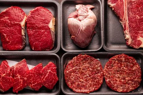 Assorted raw beef meat in plastic boxes Stock Photos