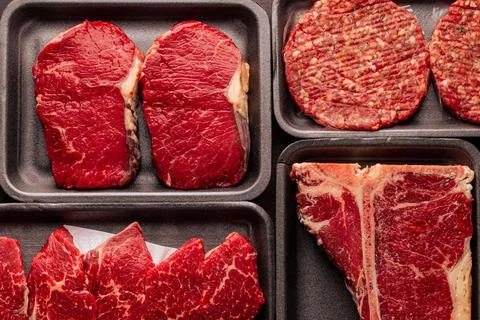 Assorted raw beef meat in plastic boxes 写真素材