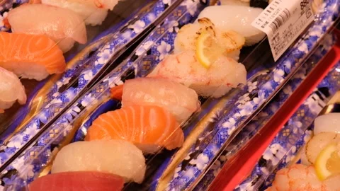 Assorted raw fish sushi packed in a box on display in japan Stock Footage 132608847