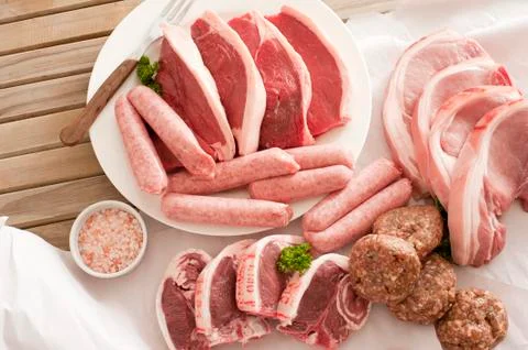 Assorted raw meat cuts with salt Stock Photos