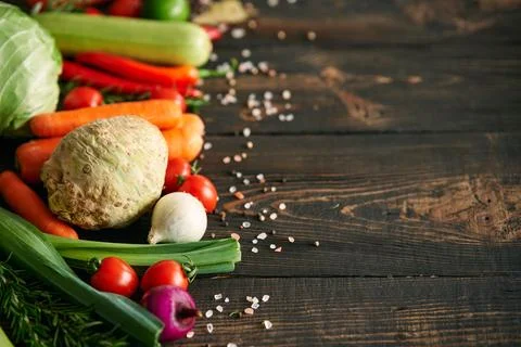 Assorted raw organic vegetables on dark wooden background with copy space Stock-Fotos