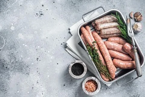 Assorted raw sausages. Beef, pork, lamb and chicken mince meat sausages in a Stock Photos