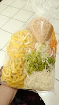 Assorted raw vegetables served with peanut sauce, boiled tofu, crackers Stock Photos