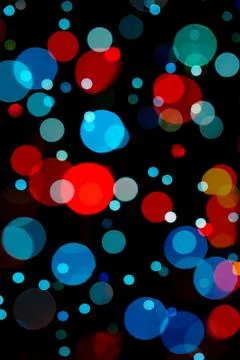 Assorted red and light blue bokeh on black Stock Photos