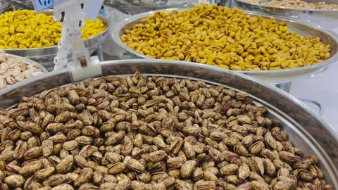 Assorted roasted nuts and seeds in metal bowls, horizontal view Stock Footage 345156466