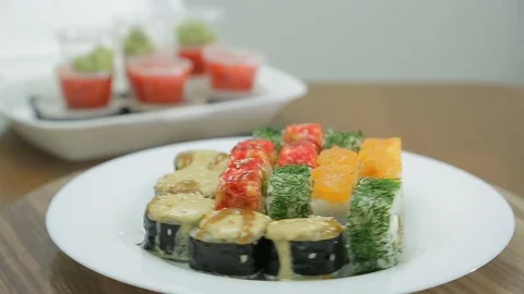 Assorted rolls on a white plate rotates in a circle Vidéo 126055053