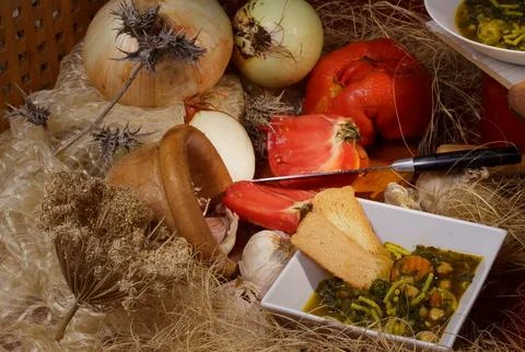 Assorted rustic kitchen ingredients with fresh vegetables and a delicious bow Stock Photos
