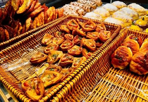 Assorted Savory Pastries in Wicker Baskets Stock Photos