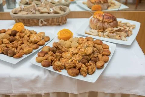 Assorted savory snacks buffet on white tablecloth Stock Photos
