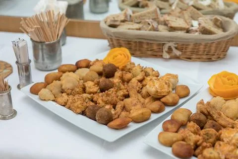 Assorted savory snacks buffet on white tablecloth Stock Photos