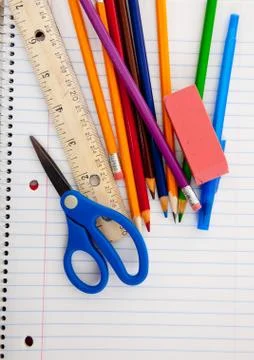 Assorted school supplies on a lined notebook Stock Photos