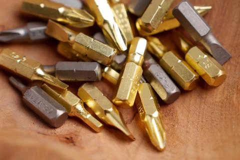 Assorted screwdriver bits on rustic wooden surface.  Stock Photos
