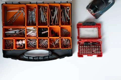 Assorted screws and hardware organized in toolbox on white background Stock Photos