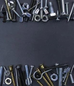 Assorted Screws, Bolts, and Nuts on Dark Background Stock Photos