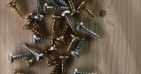 Assorted Screws on Wooden Surface Stock Footage 293369267
