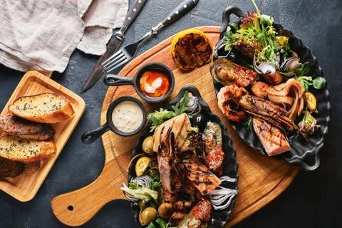 Assorted seafood on plates. Beautiful composition on a served seafood table Stock Photos
