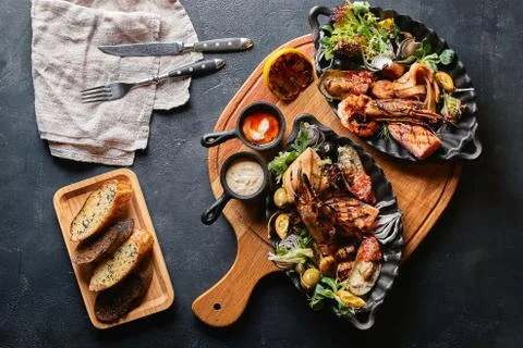 Assorted seafood on plates. Beautiful composition on a served seafood table Stock Photos