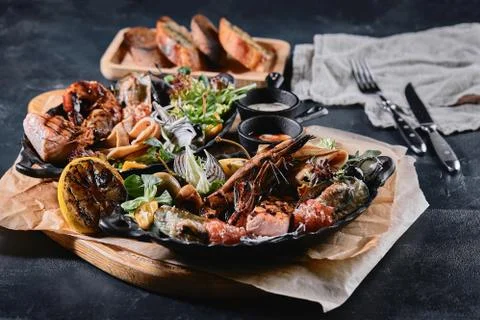 Assorted seafood on plates. Beautiful composition on a served seafood table Stock Photos