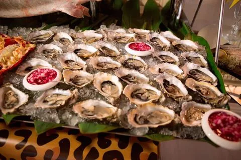 Assorted seafood on a platter with lemon and herbs 写真素材