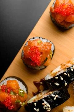 Assorted set of various rolls with salmon, tobiko calve, avocado wrapped in nori Stock Photos