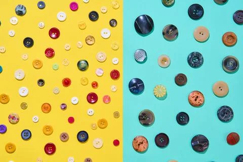 Assorted sewing buttons on yellow and blue background Foto stock