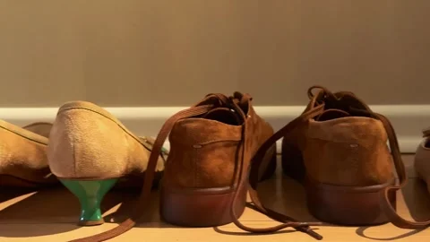Assorted shoes lined up by an entrance with smooth camera movement for hosp.. Stock Footage 340034644