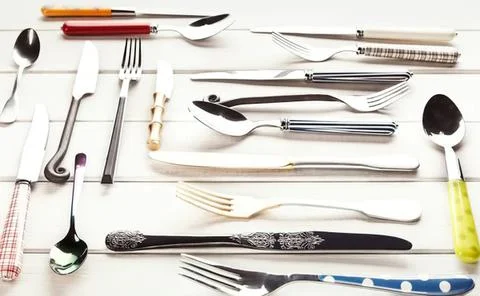 Assorted silverware on white wooden table setting Stock-Fotos