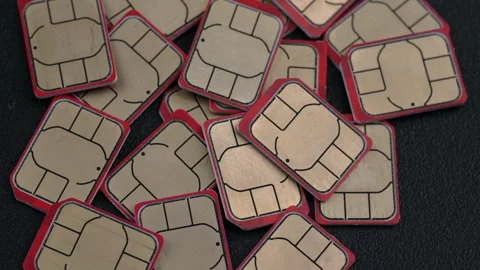 Assorted SIM Cards Piled on Dark Surface Stock Footage 337215273