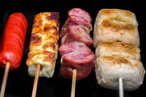 Assorted skewers on black background Stock Photos