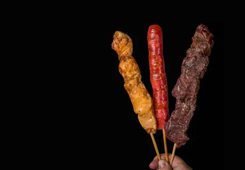 Assorted skewers on black background Stock Photos