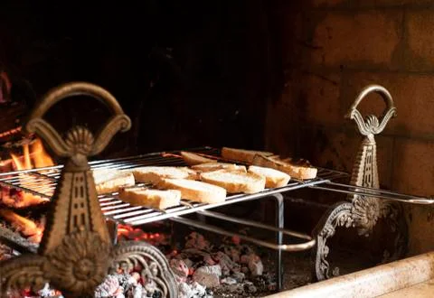 Assorted sliced bread toasting on a metal rack Stock Photos