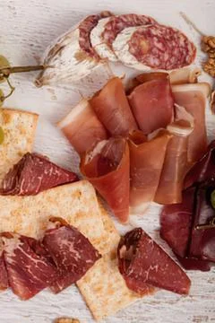 Assorted sliced cured meats on bread 스톡 사진