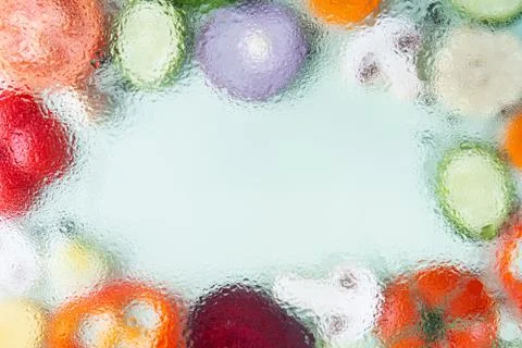 Assorted sliced vegetables on green background. Soft focus, water drops textu Stock Photos