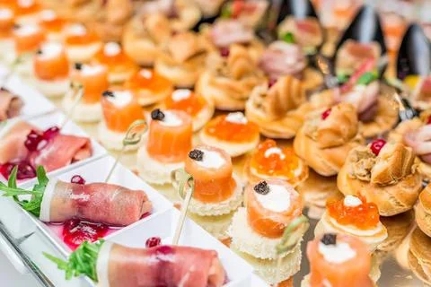Assorted small appetizers and finger foods on a buffet table Stock Photos