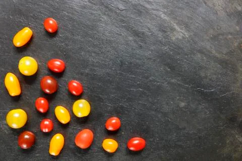 Assorted small tomatoes on slate Stock Photos